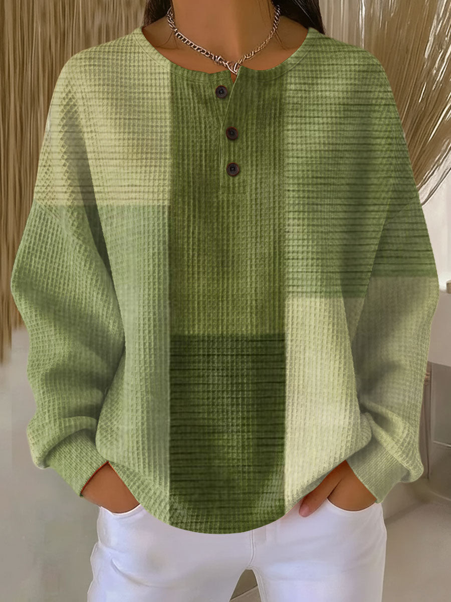 Light green waffle-knit henley jumper with darker green center panel and button placket