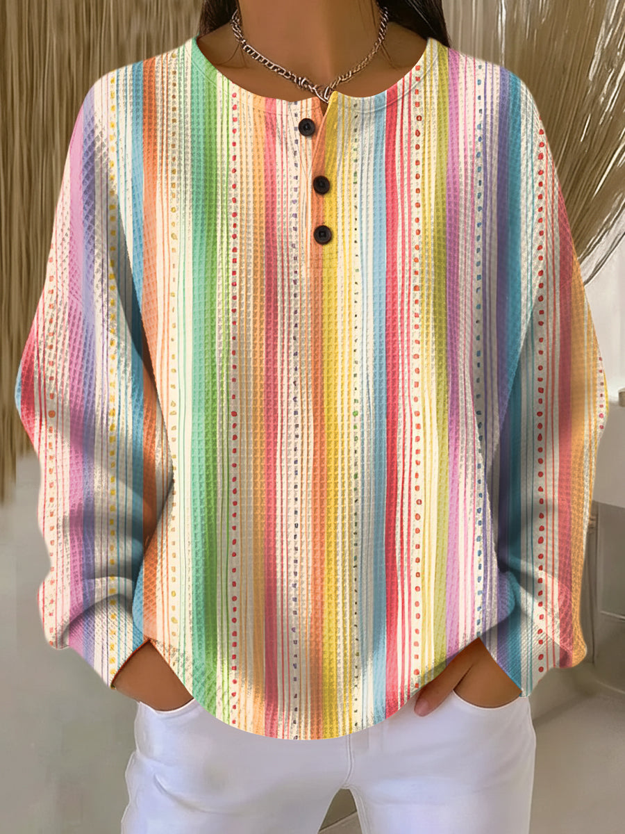 Rainbow vertical stripe waffle-knit henley jumper with black button placket and long sleeves