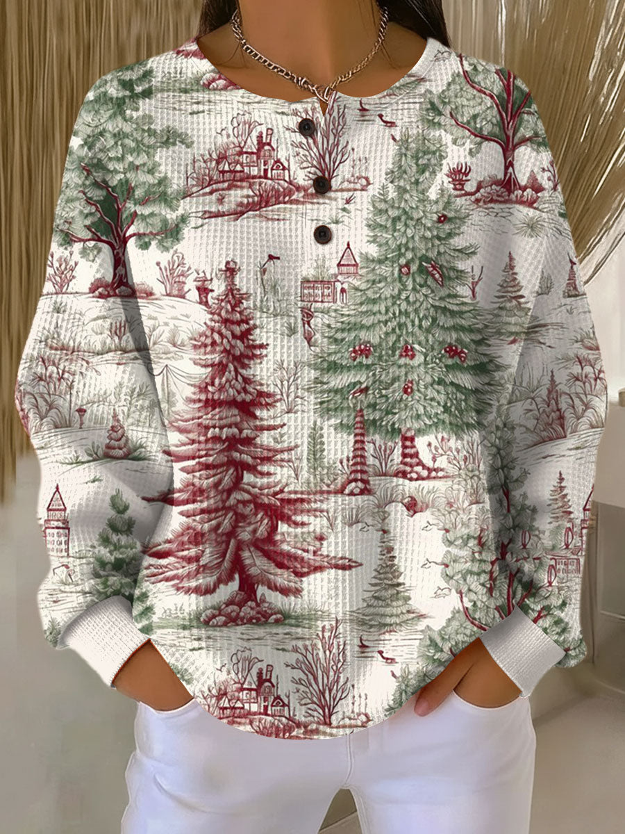 Women's off-white knit jumper with green and red holiday scene: trees, houses, ornaments
