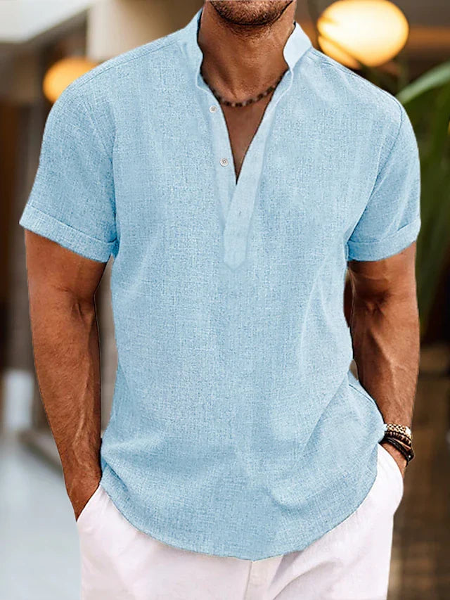 Men's light blue linen henley shirt with short sleeves and buttoned neckline.
