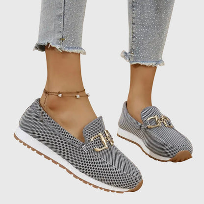 Gray orthopedic mesh loafers with gold buckle detail and rubber sole