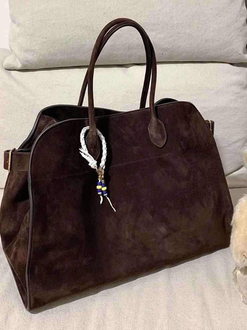 Brown suede tote handbag with two top handles and beaded keychain charm