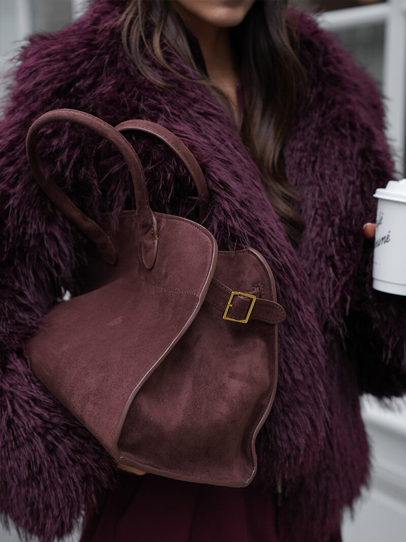 Burgundy suede shoulder tote with top handles and square gold buckle
