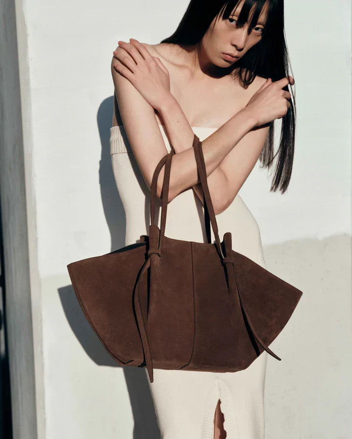 Brown suede tote bag with dual handles and long drawstring ties