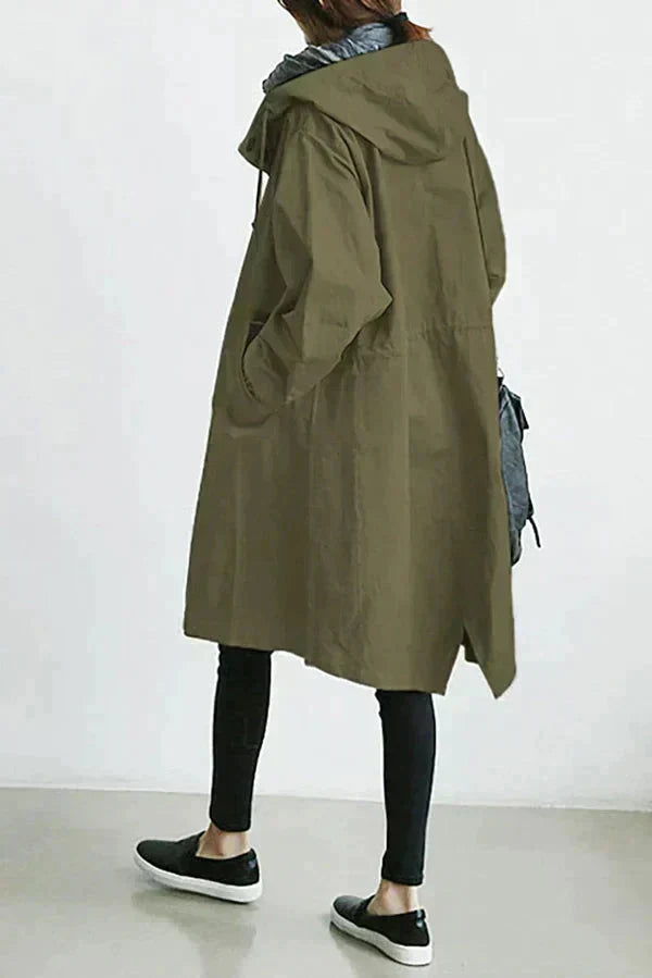 Women’s raincoat in green with oversized hood and button-front, long coat style.