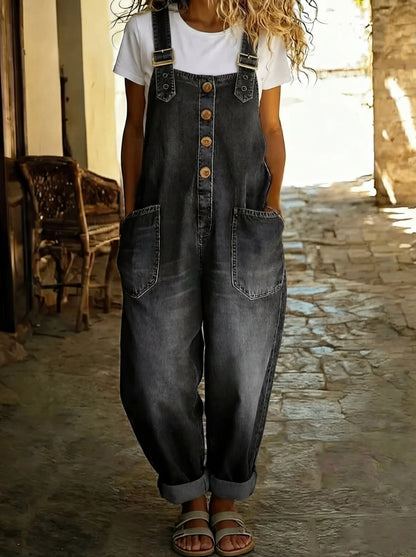 Black denim dungarees with buckle straps, front buttons and chest yoke pockets