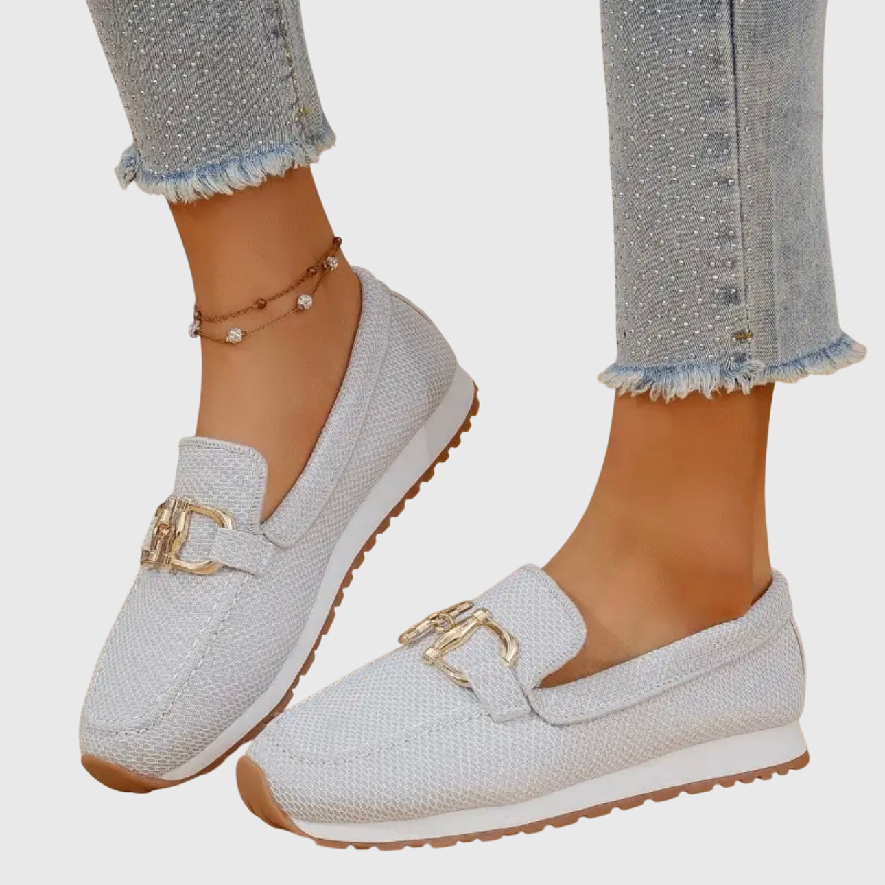 White textured ladies loafers with gold buckle detail and cushioned sole