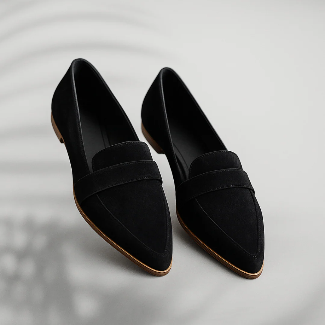 Black suede slip-on loafers with strap detail and brown rubber sole