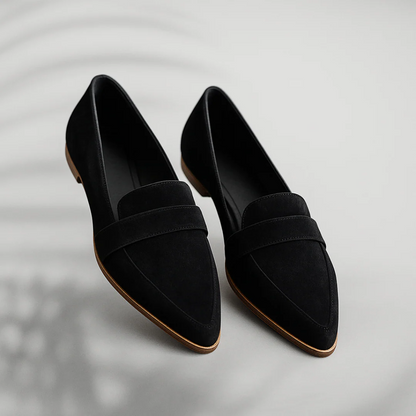 Black suede slip-on loafers with strap detail and brown rubber sole