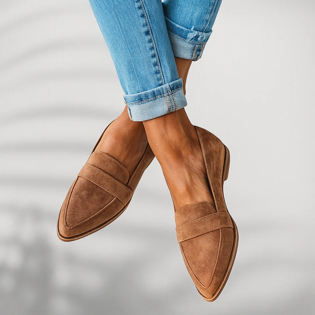Tan suede slip-on loafers with stitched seams and brown rubber sole