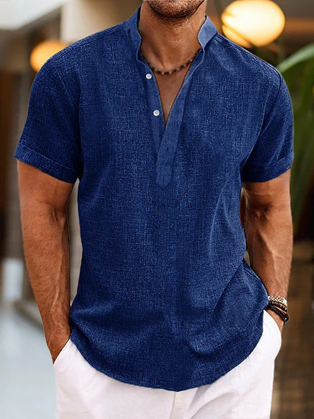 Men's blue linen henley shirt with short sleeves and buttoned neckline.