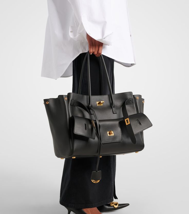 Valencia Air Bag black leather tote with gold hardware, top handles and dangling pouch
