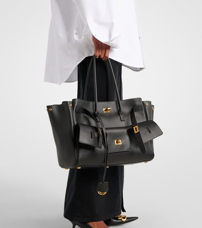 Valencia Air Bag black leather tote with gold hardware, top handles and dangling pouch