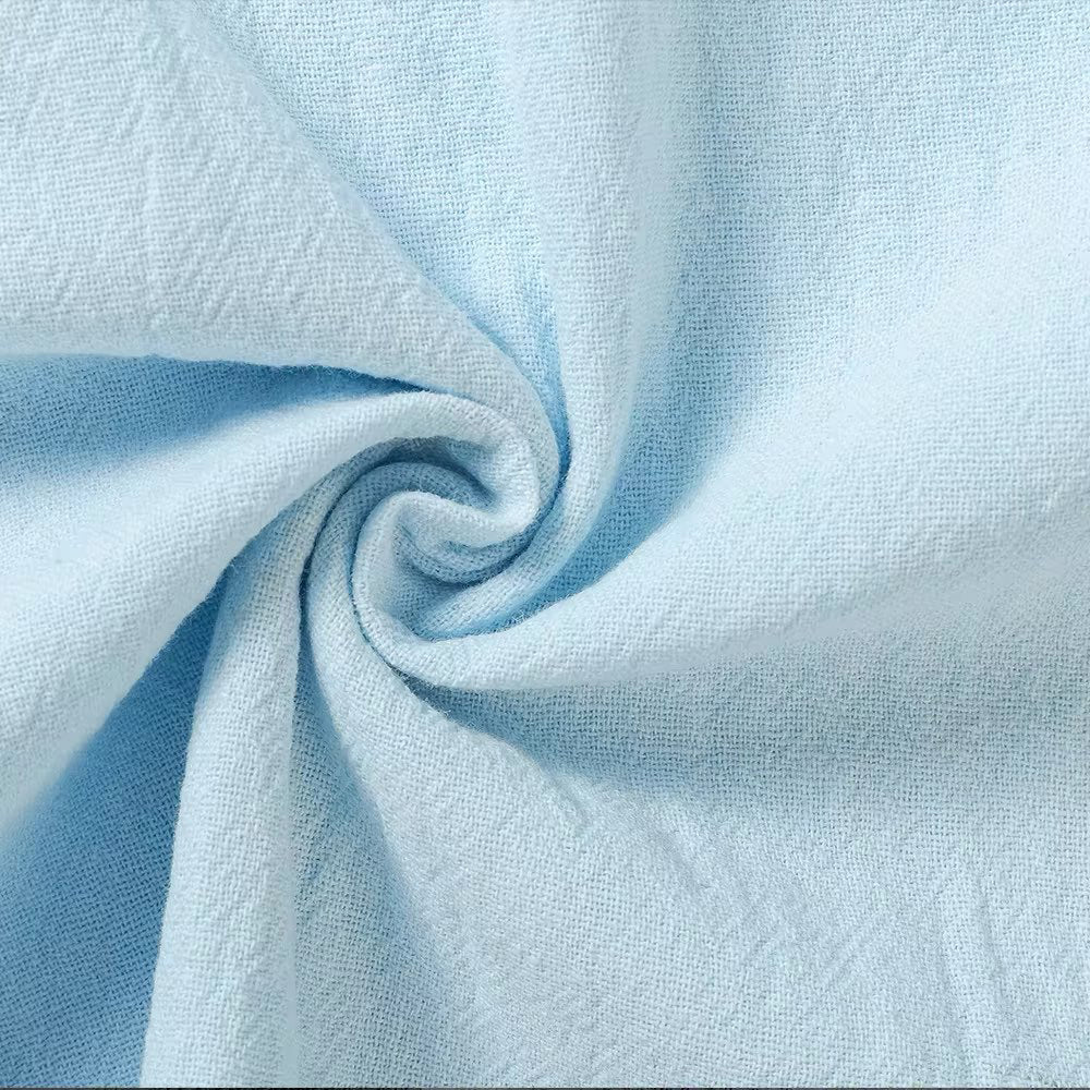 Light blue linen fabric close-up with textured weave and soft drape