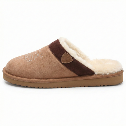 Cowboy slippers with cushioned sole, dark strap, and white faux-fur trim on the vamp.