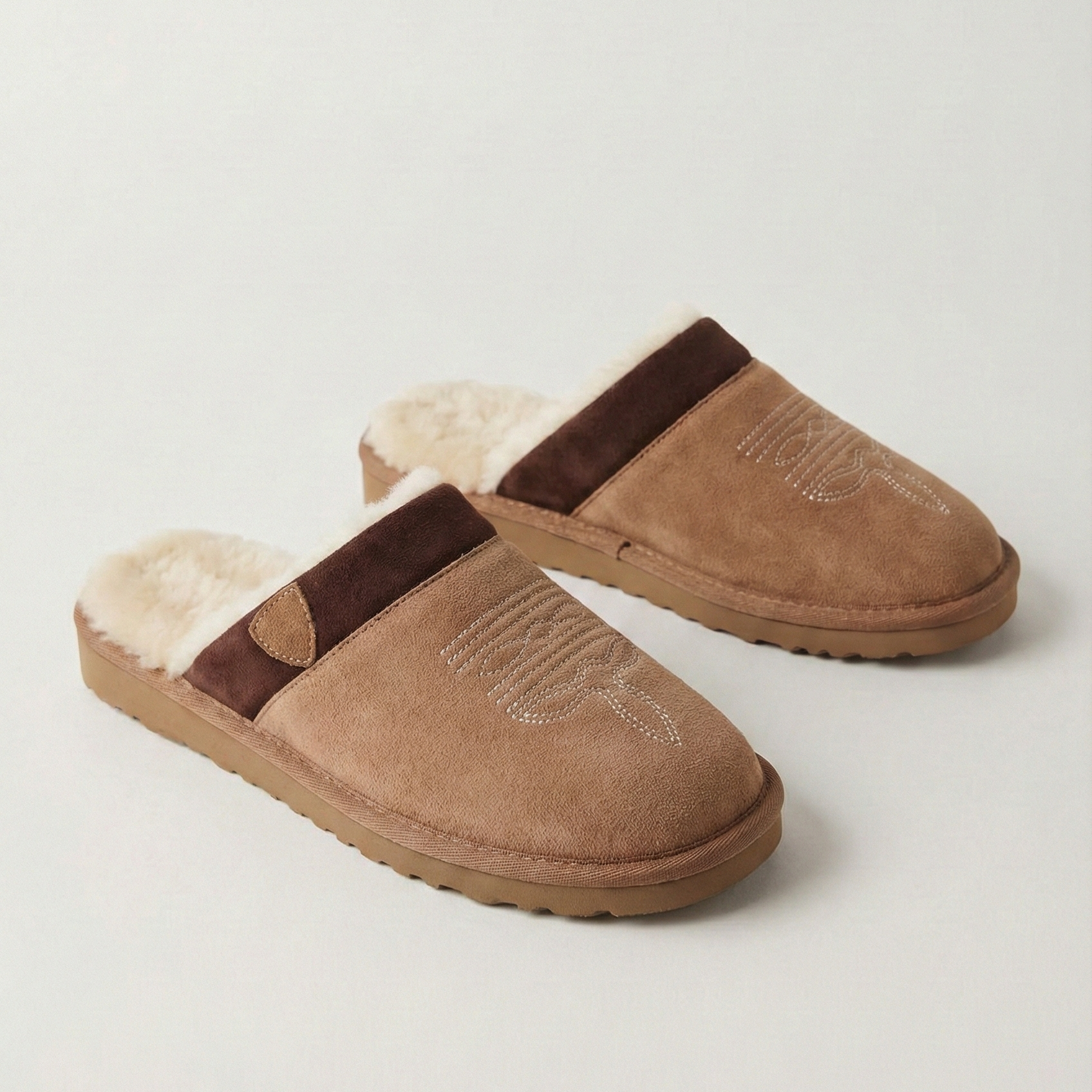 Cowboy slippers shown in two shades: chestnut and brown, each with faux-fur lining.