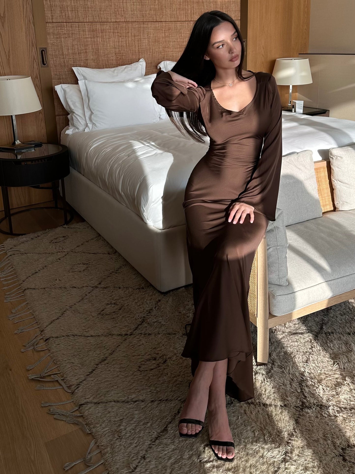 Brown long-sleeved maxi dress with fitted silhouette and side slit hem