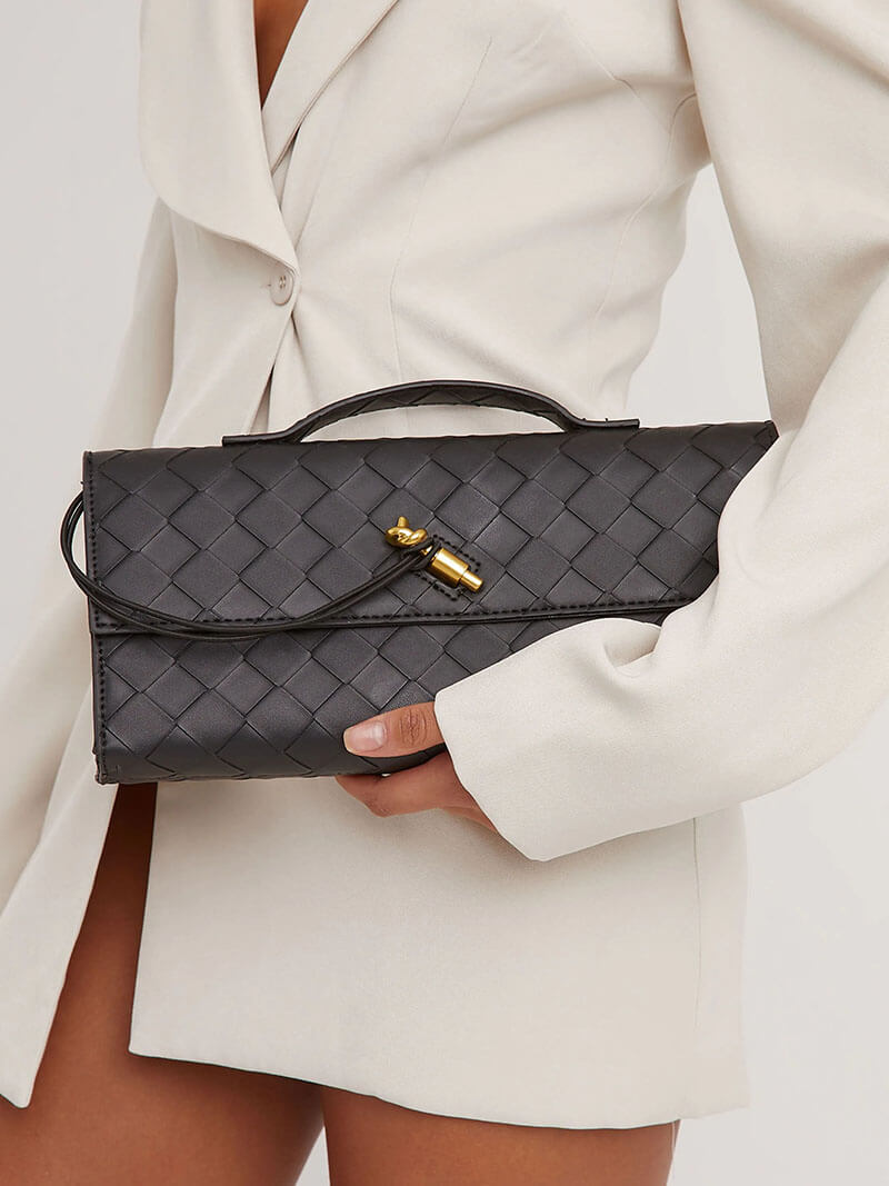 Black woven vegan leather clutch with gold clasp and detachable shoulder strap