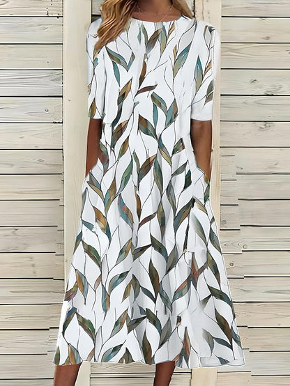 Midi dress with white base and green leaf print, round neckline, short sleeves
