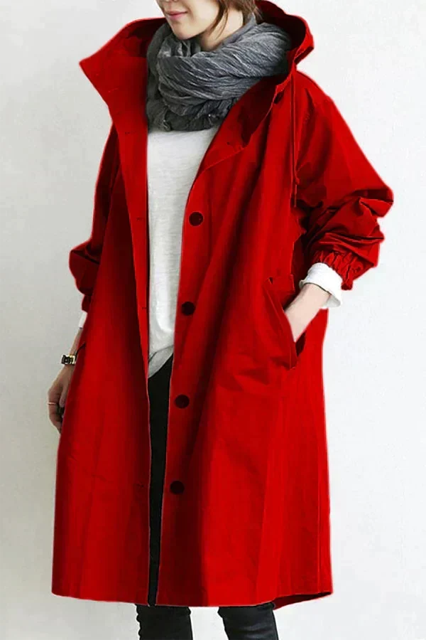Women’s raincoat in red with oversized hood and button-front, long coat length.