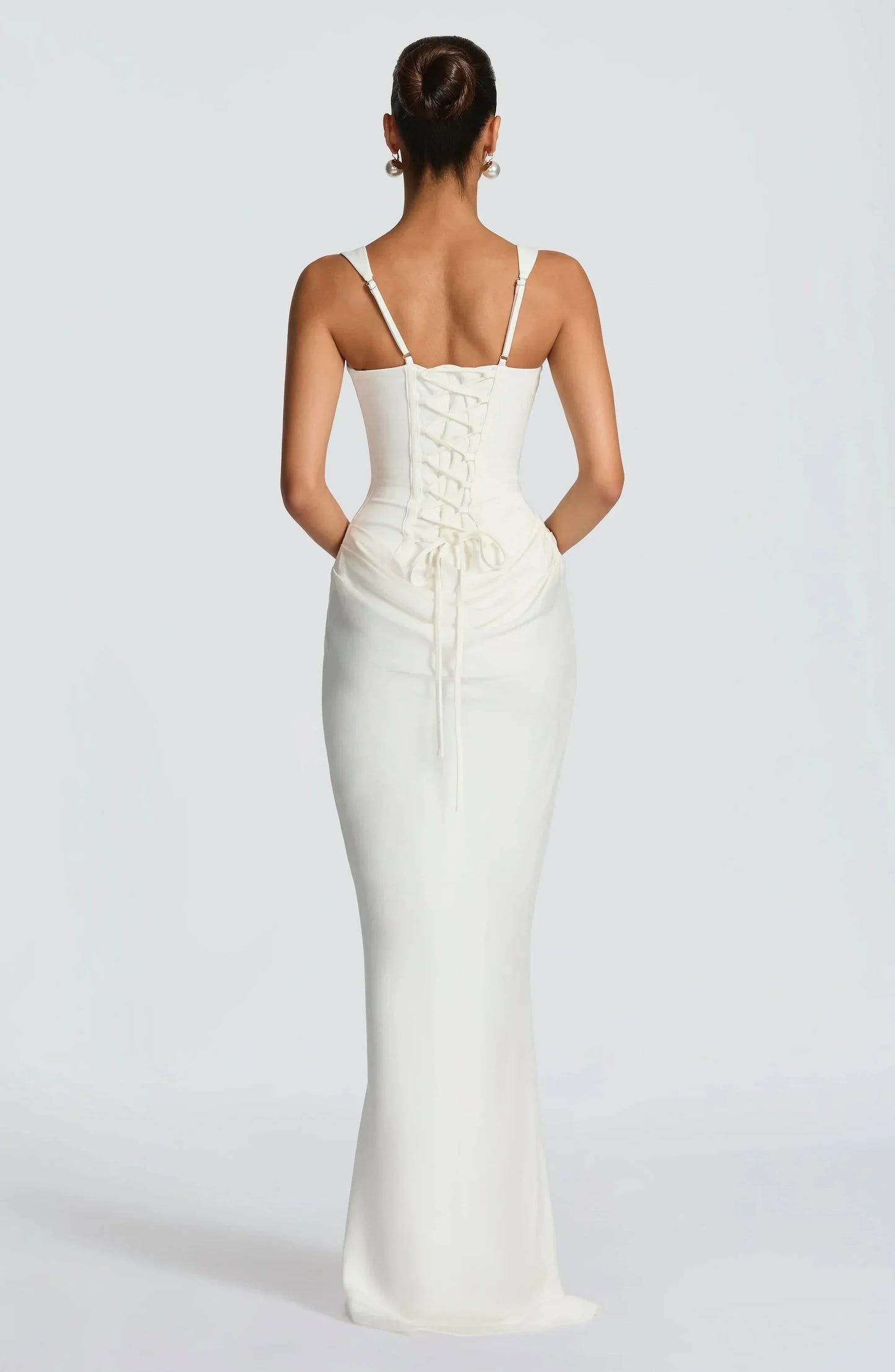 White backless maxi dress with lace-up back panel and ruched waist