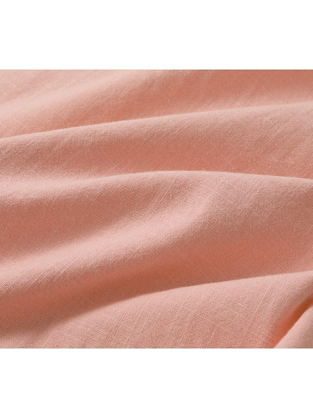 Pink linen fabric close-up with visible weave and soft texture.