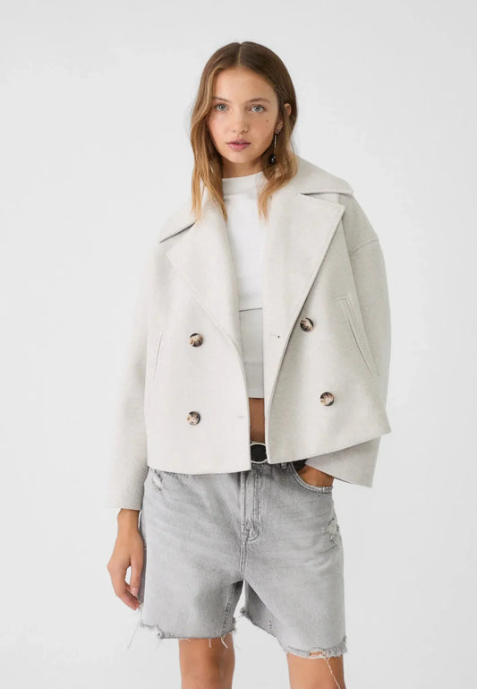 Cropped double-breasted jacket, off-white, worn with inner top and denim shorts
