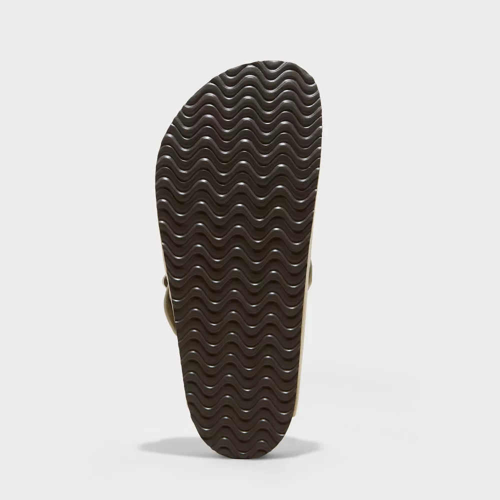 Brown suede clog outsole with wavy tread pattern