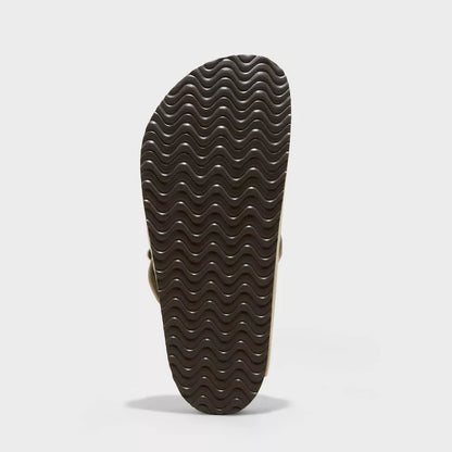 Brown suede clog outsole with wavy tread pattern
