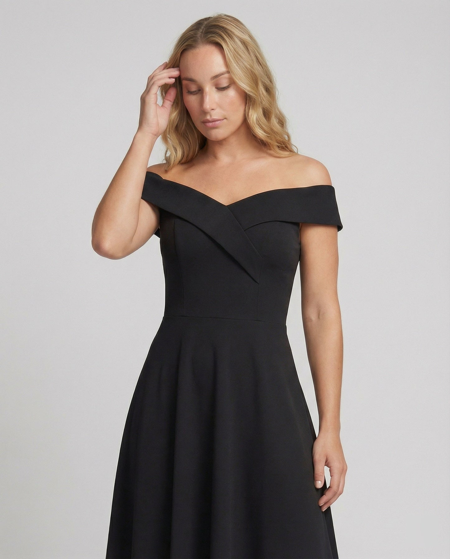 Black off-shoulder evening dress with fitted waist seam and flared skirt