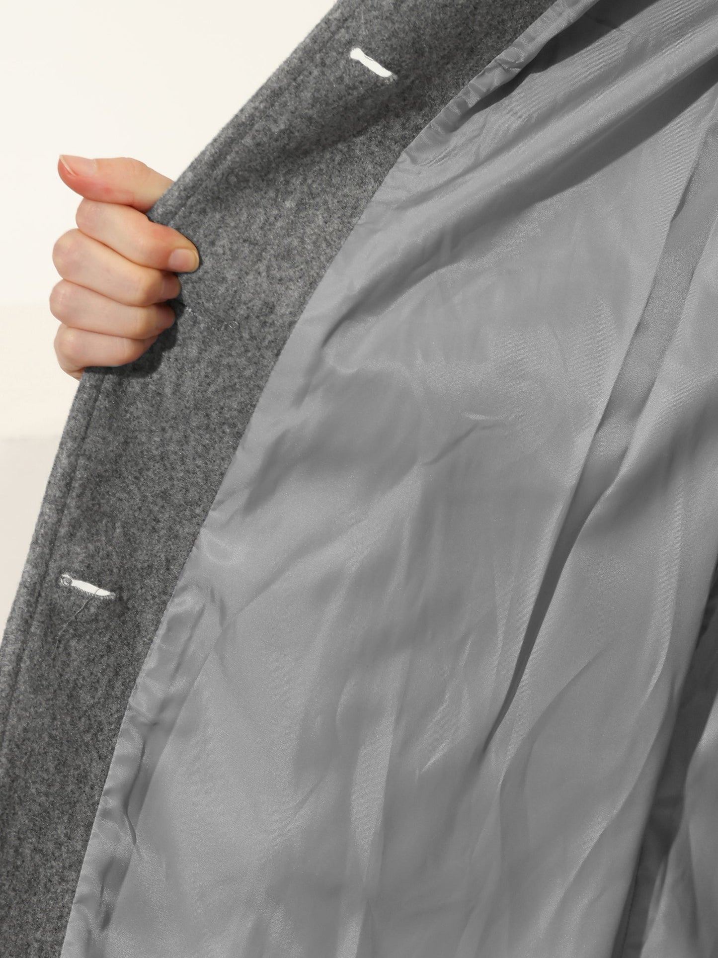Gray trench coat interior lining, smooth satin fabric visible