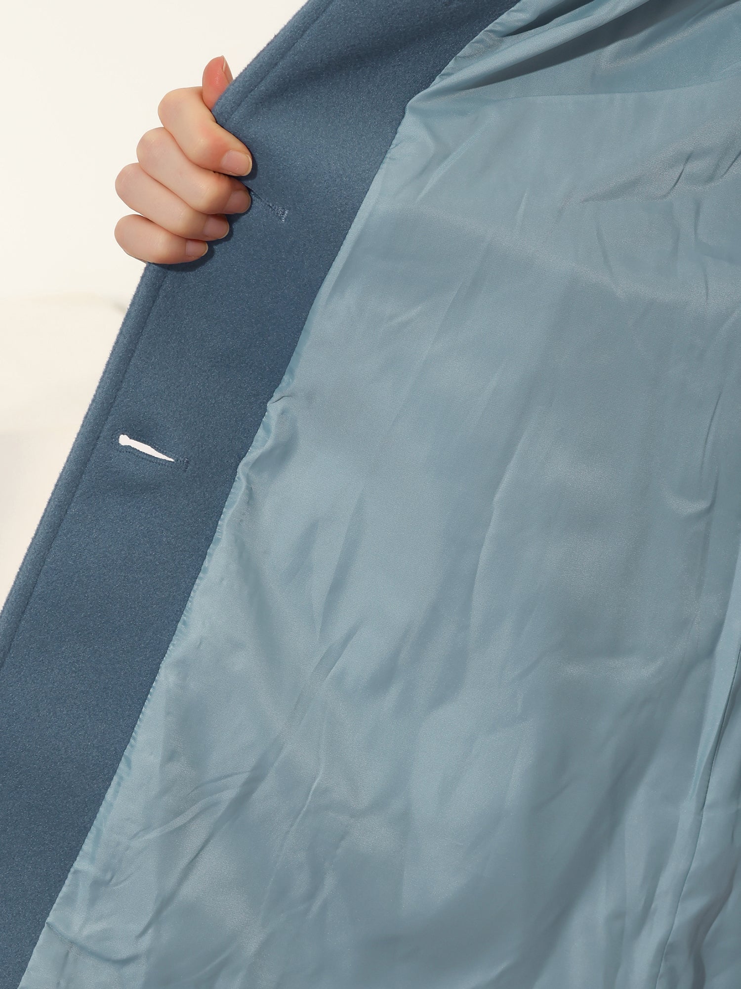 Dark blue trench coat interior lining, smooth satin fabric visible