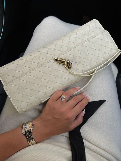Off-white woven vegan leather clutch with gold clasp and chain-style shoulder strap
